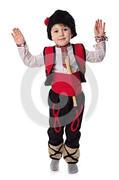 Bulgarian boy musician with flute in traditional folklore costume with martenitsa symbol of spring, Baba Marta and Easter holiday