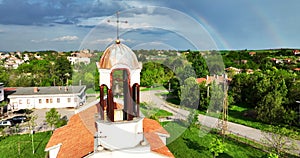 Bulgarian christian church in the countryside and beautiful bulgarian nature with rainbow in sky