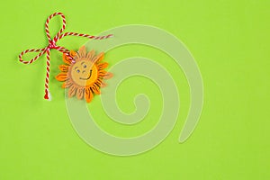 Bulgarian Martenitsa and sun on green background