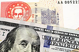 A Bulgarian one lev bill with an American one hundred dollar bill