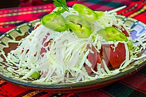 Bulgarian Shopsky Salad made of tomatoes, cucumbers and cheese