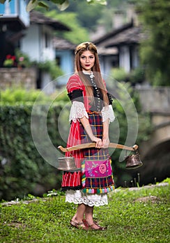 Bulgarian woman wearing a traditional costume in the Ethno village of Etar in Gabrovo, Bulgaria