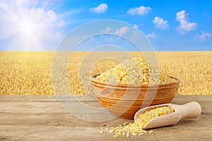 Bulgur in bowl on nature background