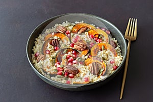 Bulgur with pumpkin, pomegranate and pecan nut. Healthy eating. Vegetarian food