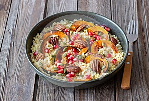 Bulgur with pumpkin, pomegranate and pecan nut. Healthy eating. Vegetarian food