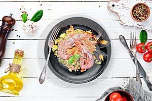 Bulgur with shrimp, mussels and vegetables. On the old background.