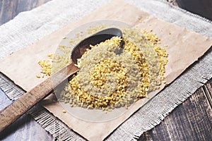 Bulgur and spoon on a wooden table