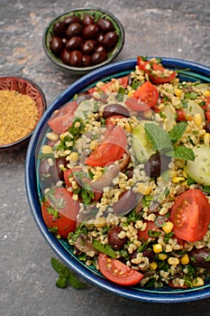 Bulgur tabouleh salad with vegetables in a bowl