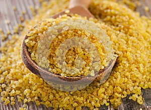 Bulgur in a wooden spoon