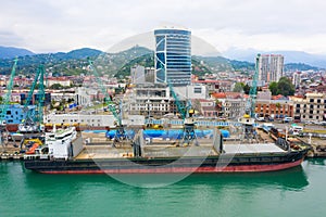 Bulk cargo ship under port crane, Batumi seaport, Georgia