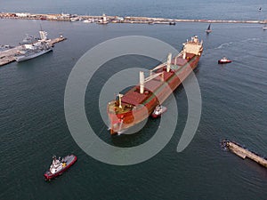 bulk carrier cargo ship enters the port for unloading in the evening