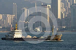 Bulk carrier passing skyscrapers of Hong Kong