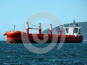 Red Cargo Ship Underway to Port