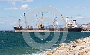 A bulk carrier ship loading cargo at port