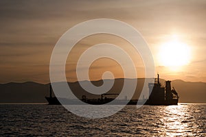 Bulk-carrier ship at sunset