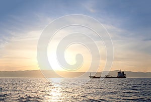 Bulk-carrier ship at sunset