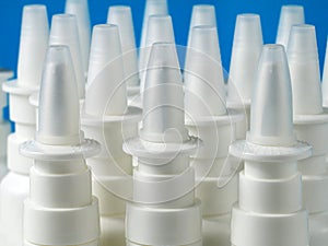 A bulk of nasal spray bottles on blue background