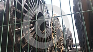 Bulk sub-sea industrial glass fiber optic cable on a metal spool on a ship's stand.