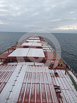 a bulkcarrier ship covered by light snow photo