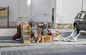 Bulky waste on the street. Broken beds, garbage furniture on pavement ready for bulky waste collection.