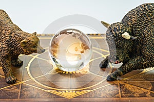 Bull and bear market, world stock exchange symbol for high and low season concept, bear and bull figures with the shinny globe