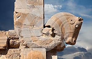 Bull Figure from Achaemenid Dynasty as a Column Capital in Persepolis of Iran Against Cloudy Blue Sky