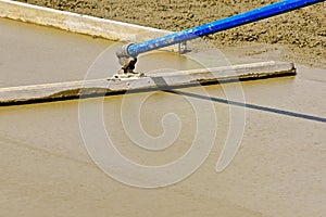 Bull float being used on a concrete project