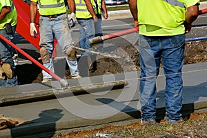 Bull float being used on a freshly poured sidewalk
