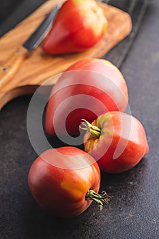 Bull heart tomatoes on black table