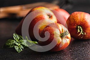 Bull heart tomatoes on black table