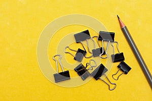 Bulldog paperclips isolated on yellow background