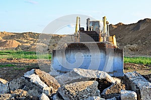 Bulldozer with bucket for pool excavation and utility trenching. Dozer during demolition concrete and asphalt at construction site