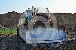 Bulldozer with bucket for pool excavation and utility trenching. Dozer during demolition concrete and asphalt at construction site