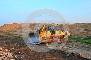 Bulldozer with bucket for pool excavation and utility trenching. Dozer during demolition concrete and asphalt at construction site