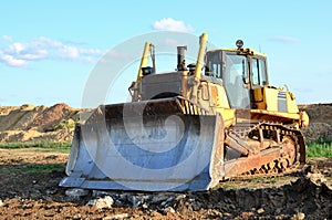 Bulldozer with bucket for pool excavation and utility trenching. Dozer during demolition concrete and asphalt at construction site
