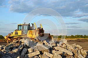 Bulldozer with bucket for pool excavation and utility trenching. Dozer during demolition concrete and asphalt at construction site