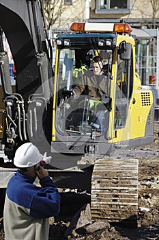 Bulldozer and building workers