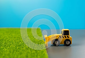 Bulldozer clears fertile land for construction.