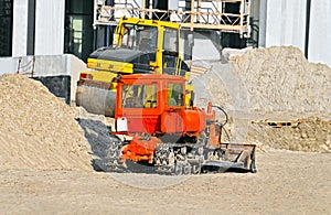 Bulldozer and compactor on construction