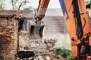 bulldozer crushing an old building at construction site