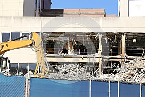 Bulldozer deconstructing building. Construction industry concept.
