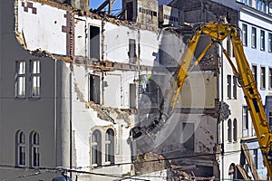 A bulldozer is demolishing an old building construction site in Vienna