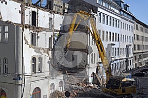 A bulldozer is demolishing an old building construction site in Vienna