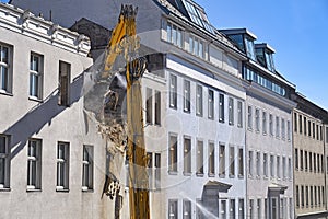 A bulldozer is demolishing an old building in Vienna