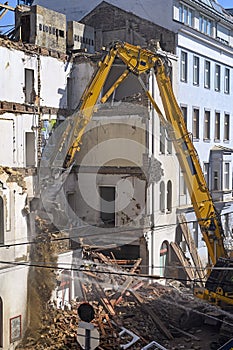 A bulldozer is demolishing an old building in Vienna photo