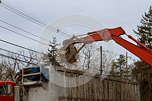 A bulldozer destroys of the demolition of a building under construction of a new house