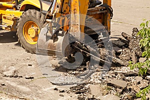 Bulldozer Dismantles Asphalt at Work