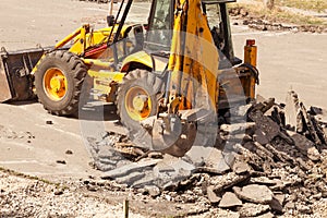 Bulldozer Dismantles Asphalt at Work