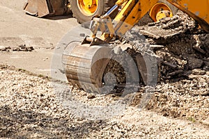 Bulldozer Dismantles Asphalt at Work