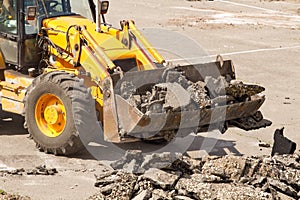 Bulldozer Dismantles Asphalt at Work